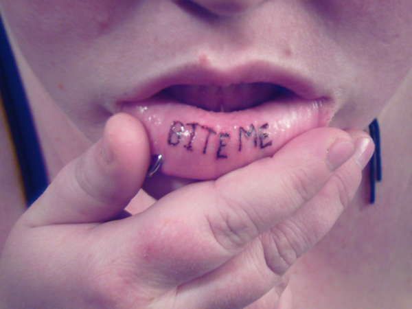 With the word bite. Татуировка на нижней губе. Тату на внутренней стороне губы.