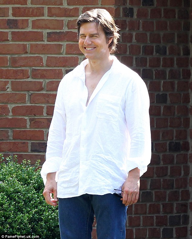 Clean-cut: The 52-year-old actor sported a loose-fitted and wrinkled white button-up dress shirt and blue jeans, paired with brown leather slip-on shoes