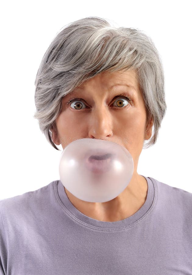 Adult Woman Blowing Chewing Gum. Adult Woman with Short Gray Hair Blowing Chewing Gum with Eyes Wide Open Looking at Camera. Isolated on White Background royalty free stock photography