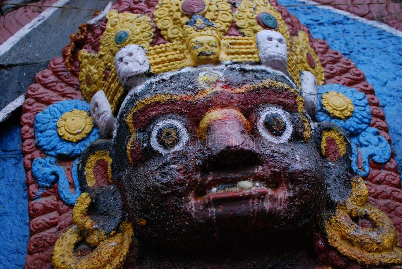 The big black god statue Nepal-face. The big black god is a single head with six arms, with open eyes in the forehead, high cyanosis, and a two-layered skull on royalty free stock images