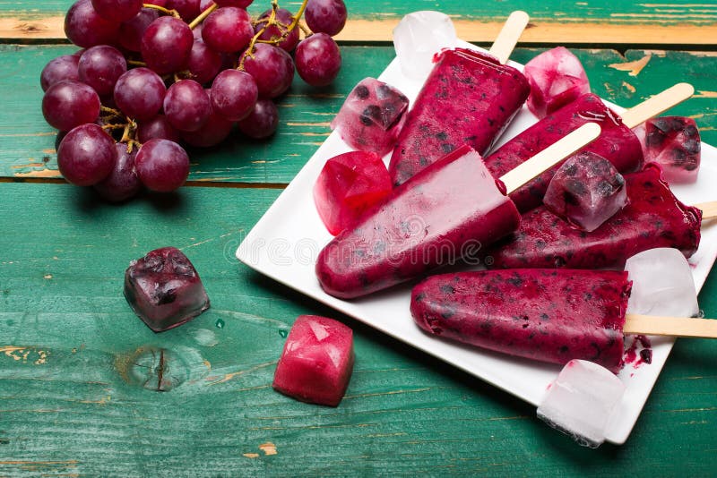 Blueberry and grape ice cream on a stick stock photography