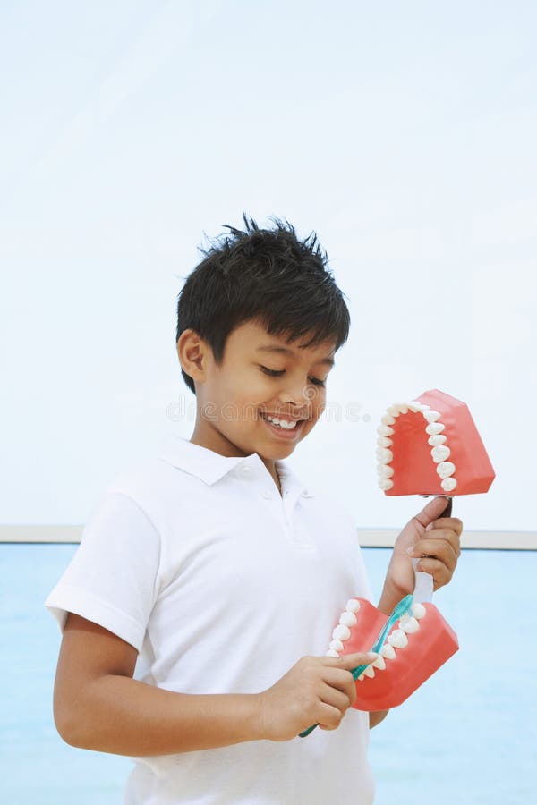 Boy showing the correct way to brush teeth. Conceptual image.  royalty free stock image