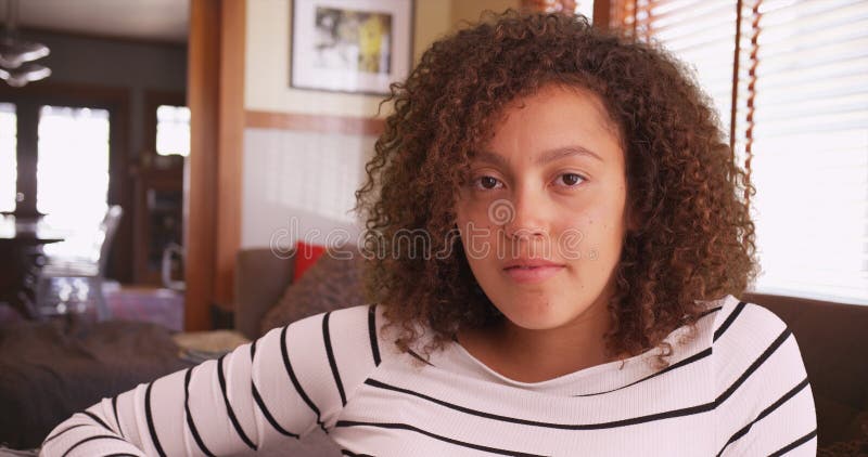 Close-up of African American woman sitting in living stock photo