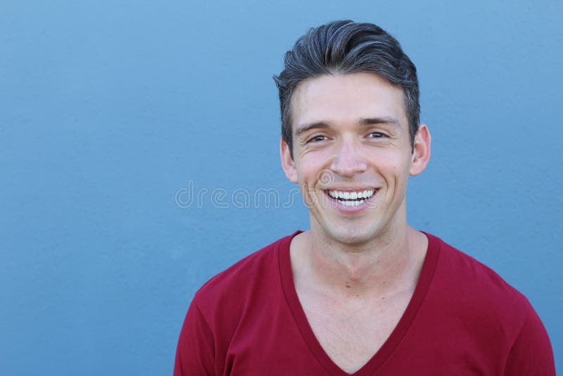 Closeup cropped portrait, young healthy man teeth, lips and smile. over blue background.  stock photos