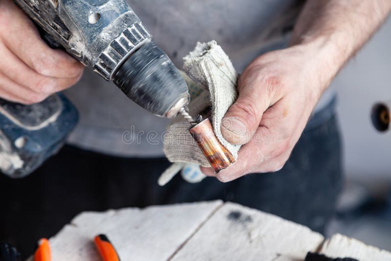 Closeup worker plumber master cleaning copper pipes with professional brush. Concept installation, changing pipeline, solder flux. Paste, professional repair royalty free stock images