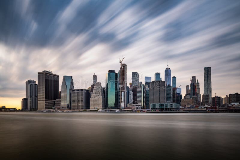 Dark clouds comming quickly over the New York Lower Manhattan during cloudy day stock photography