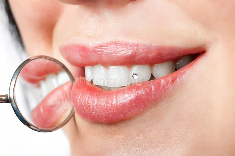 Dental mouth mirror near healthy white woman teeth royalty free stock images