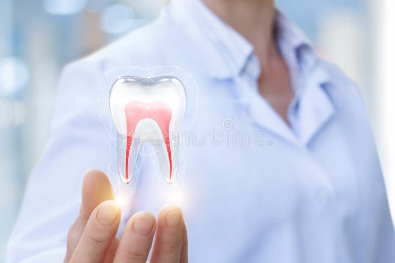 Doctor shows tooth. Doctor shows tooth on a blue background stock photo