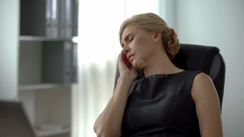 Female office manager holding hand on cheek, suffering from dental pain, health. Stock photo royalty free stock photo