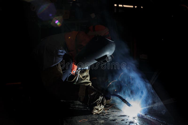 Flux cored wire arc welding process. Worker fabricate structure by flux cored wire arc welding process stock photography
