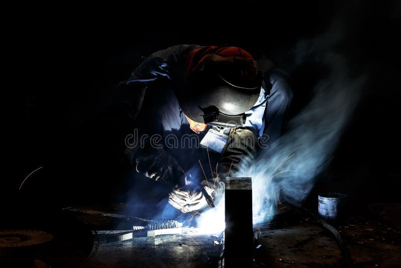 Flux cored wire arc welding process. Worker fabricate structure by flux cored wire arc welding process royalty free stock photo