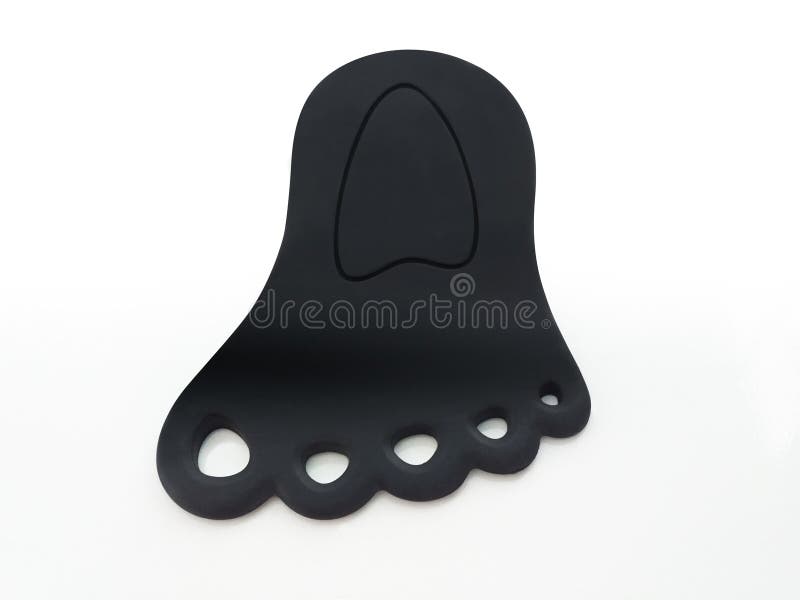 Foot shaped black rubber door wedge isolated on white background. Original aerial view of Black door rubber bracket royalty free stock images