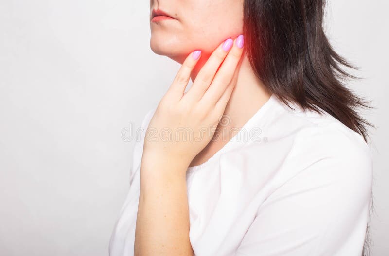 The girl clings to the inflamed salivary gland in which pain. Concept of salivary gland disease, mumps, cancer, copy space. Retention cyst royalty free stock images