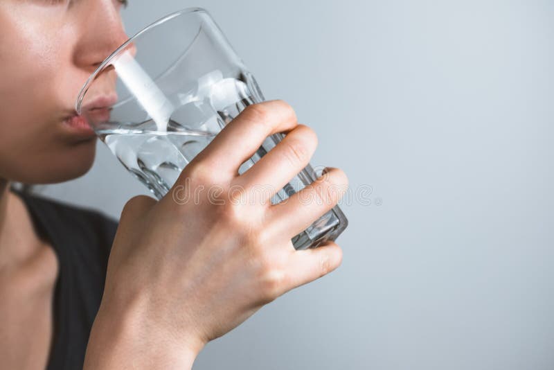 Girl drinks water. Problem skin concept. High quality photo royalty free stock images