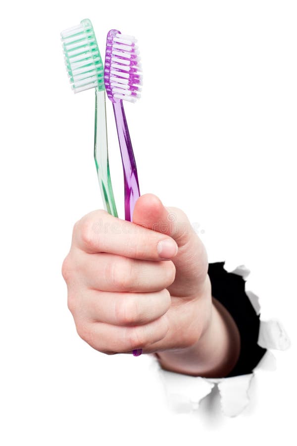 Hand holding tooth brushes royalty free stock photos