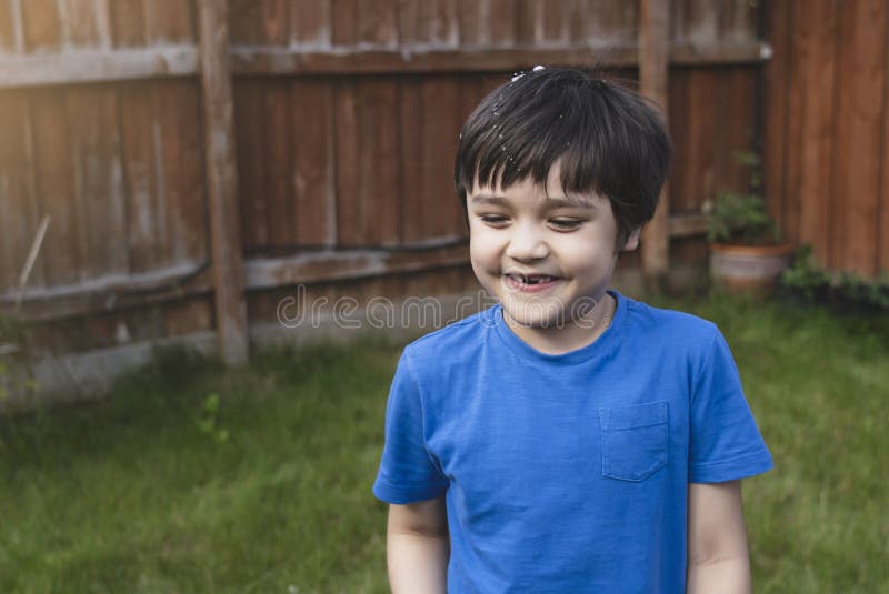 Happy 6-7 year old boy smiling and showing his missing teeth. Cute child boy lost front milk tooth. Kid having fun playing with royalty free stock photos