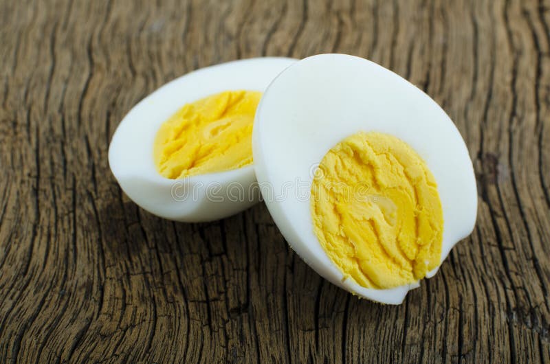 A hard boiled egg sliced in two ready to be eaten. stock images
