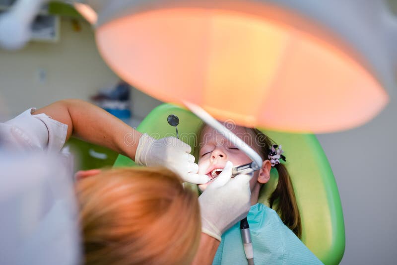 Healthy teeth patient girl at dentist office stock photo