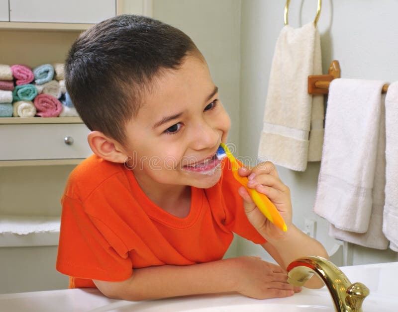 Kid brushing teeth royalty free stock photo