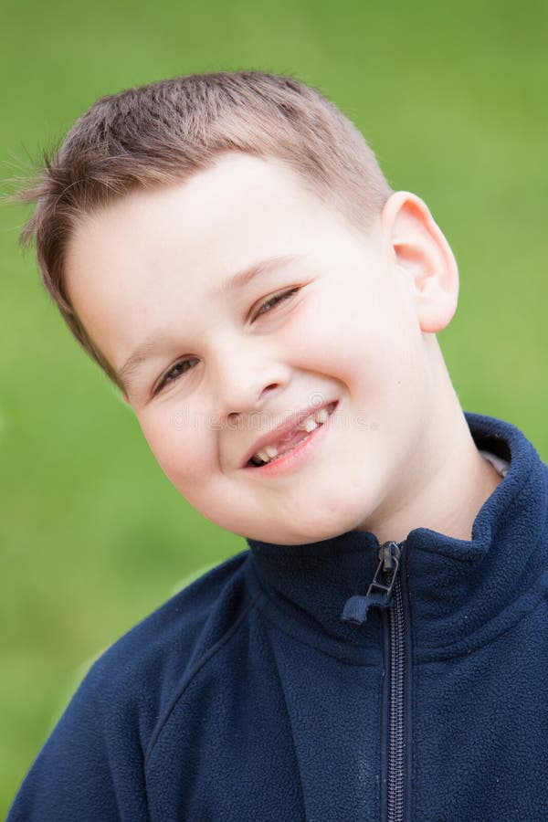 Little boy with a torn front first milk tooth stock photos