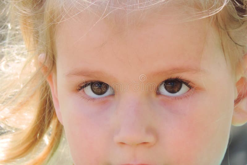 Little girl gazes brown eyes. / Children Protection Day royalty free stock image