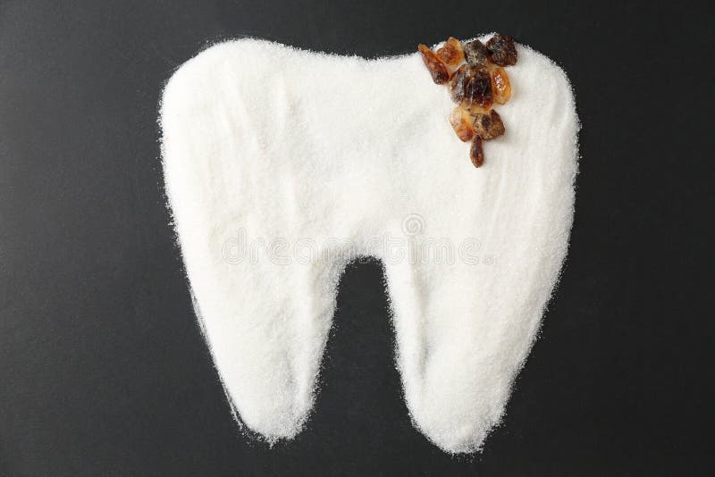 Molar tooth made of sugar on dark background stock photo