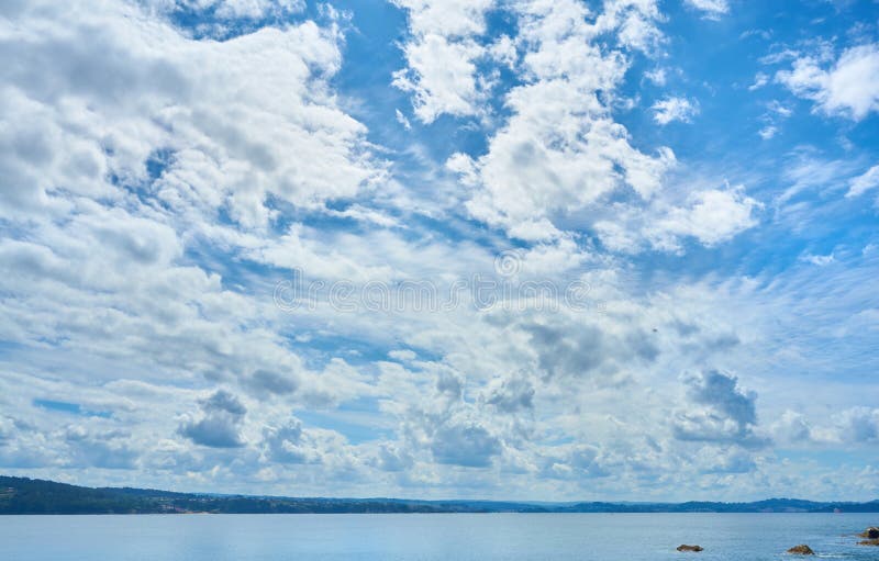 Nice photograph of the sky with clouds and the sea on the lower horizon stock photography