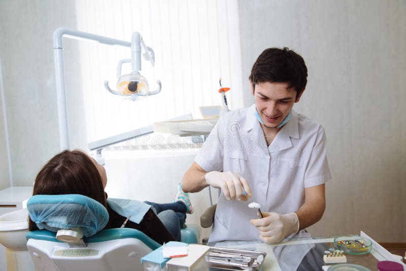 Professional dentist doing teeth checkup on female patient dental surgery. Concept of healthy royalty free stock photos