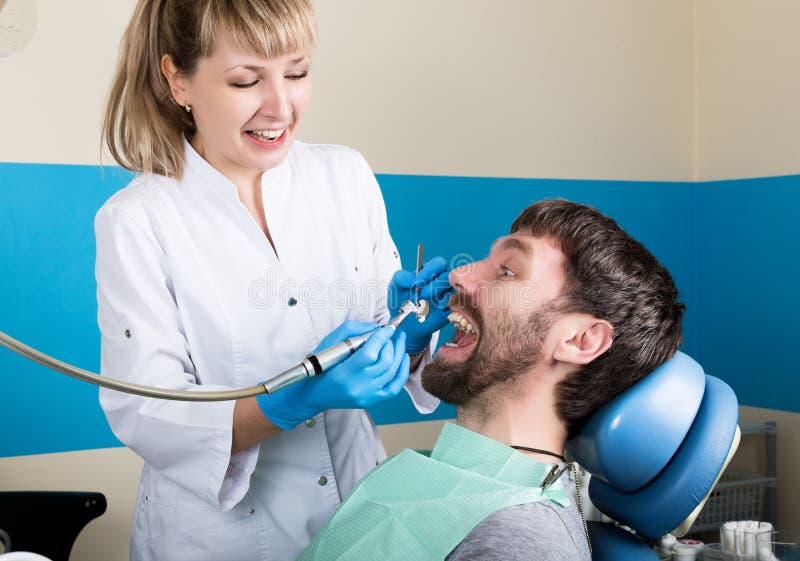 The reception was at the female dentist. Doctor examines the oral cavity on tooth decay. Caries protection. doctor puts royalty free stock images