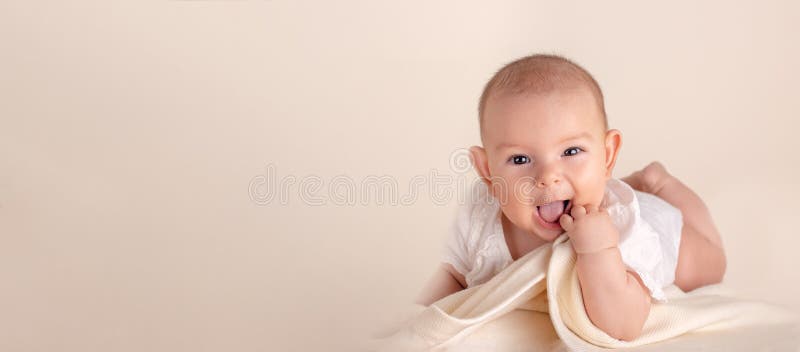 Small cute funny baby infant smiling happily and fingers in mouth sore gums. Soothe royalty free stock photos