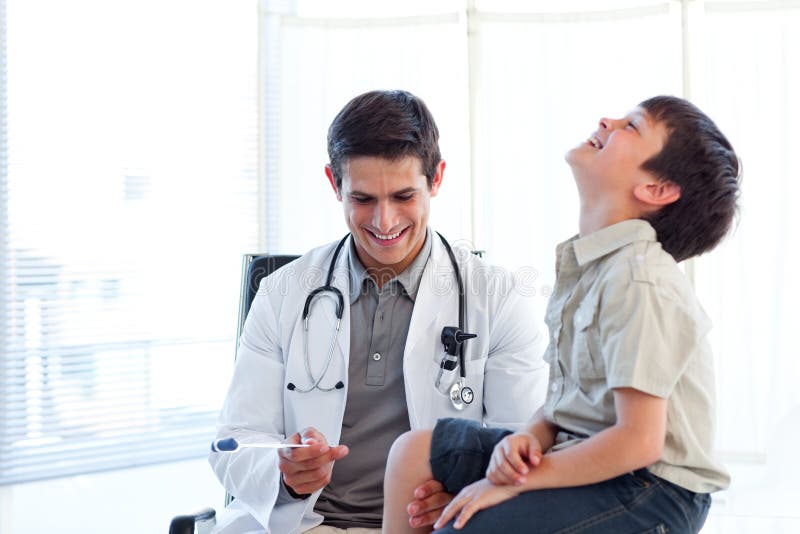 Smiling doctor checking a child