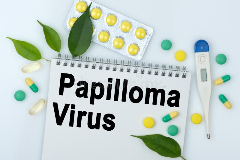 On the table are pills, a thermometer, leaves and a notebook with the inscription -Papilloma Virus. The concept of medicine royalty free stock photos