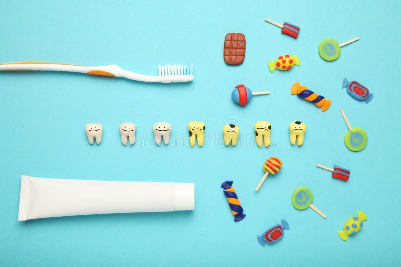 Teeth with sweet candies. Tooth caries in children`s, dental healthcare, toothpaste and toothbrush royalty free stock image