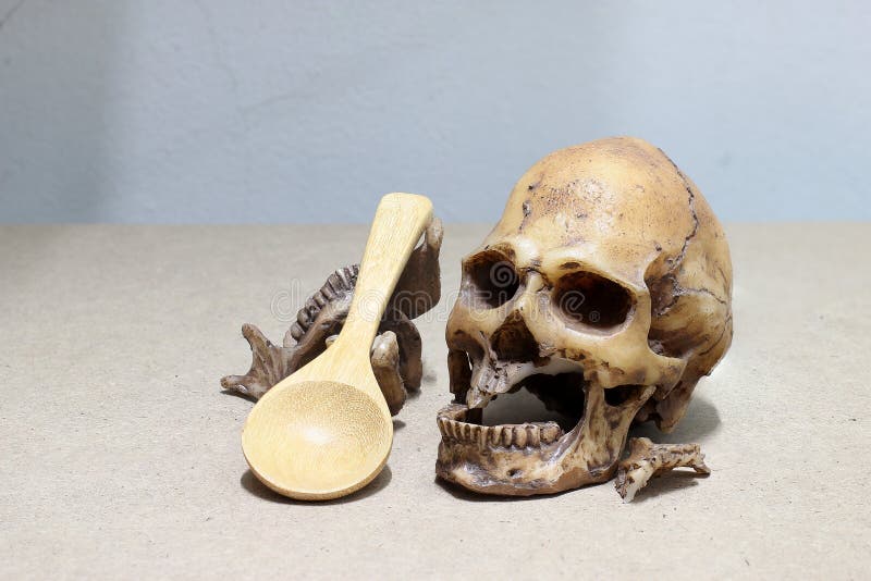 Tooth with caries, Broken teeth, human skull with wood spoon on wood background. - still life. stock images