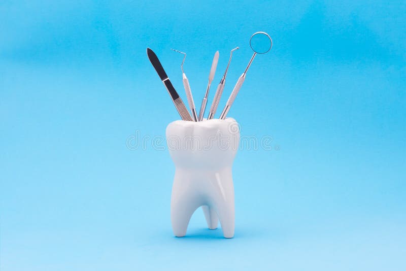 tooth model in the form of a stand with dental instruments inside. The concept of harvesting the background and copy space used i stock image