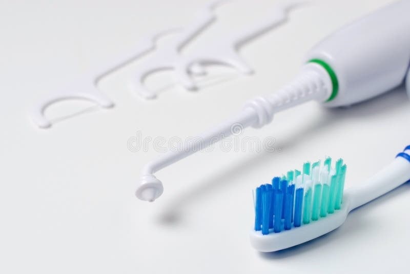 Toothbrush, tartar removal device, and floss on a white background royalty free stock photography