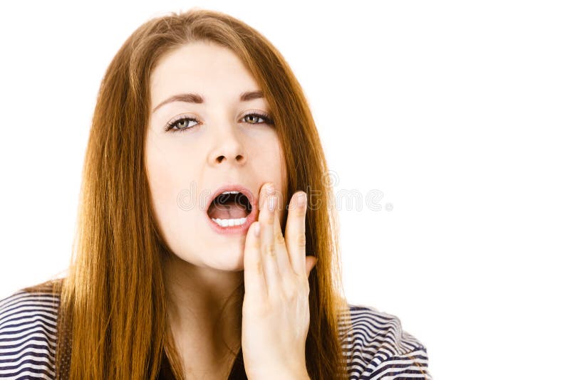 Unhappy woman touching her cheek feeling pain. Tooth ache, dentistry problems concept. Isolated background stock photo
