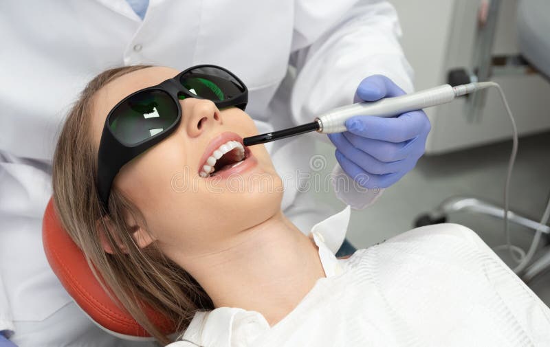 Using a modern method of laser teeth treatment. Dental care, perfect smile stock image