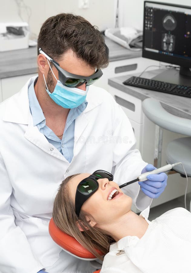 Using a modern method of laser teeth treatment. Dental care, perfect smile stock photo