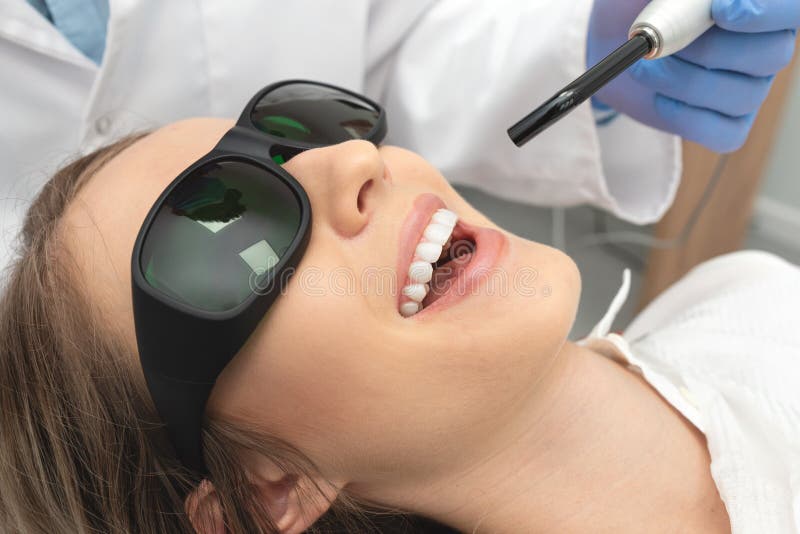 Using a modern method of laser teeth treatment. Dental care, perfect smile royalty free stock photos