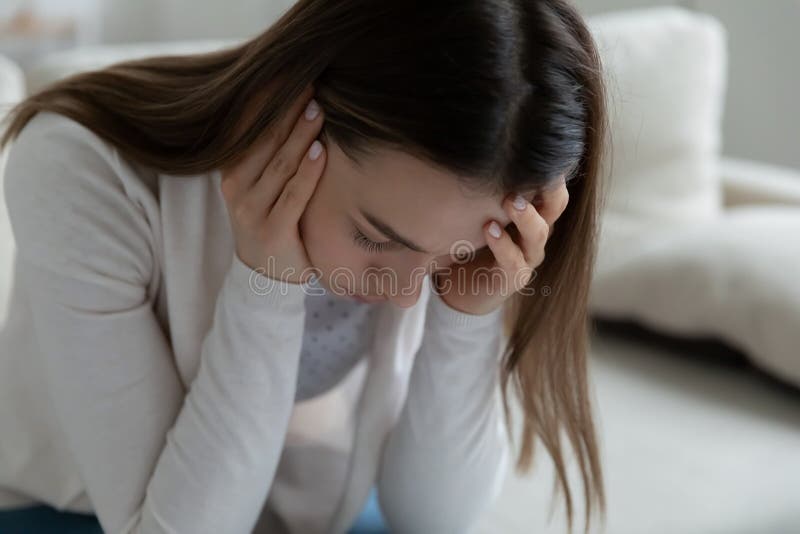 Woman sit on couch having mental personal problems feels desperate. Close up desperate woman sitting on couch feels hopeless, unhealthy girl having psychological royalty free stock photo