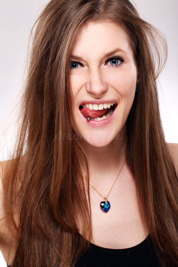 Young girl with piercing in tongue stock photo