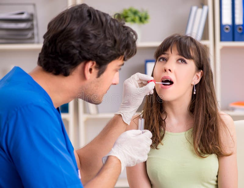 Young woman visiting male doctor dentist for removal of tartar royalty free stock photography