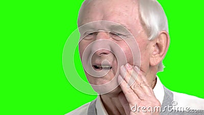Close up old man massaging touching his cheek. Grandpa touching his cheeck because of teeth pain, close up, green hromakey backgorund stock video footage